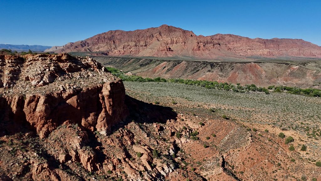 Red bluffs above a green desert valley near Ivins, Utah